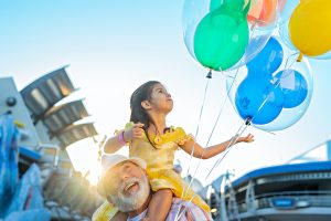 A young girl plays with a Mickey Balloon at Walt Disney World. The balloon will need to be deflated before boarding a plane at Orlando International Airport (MCO)