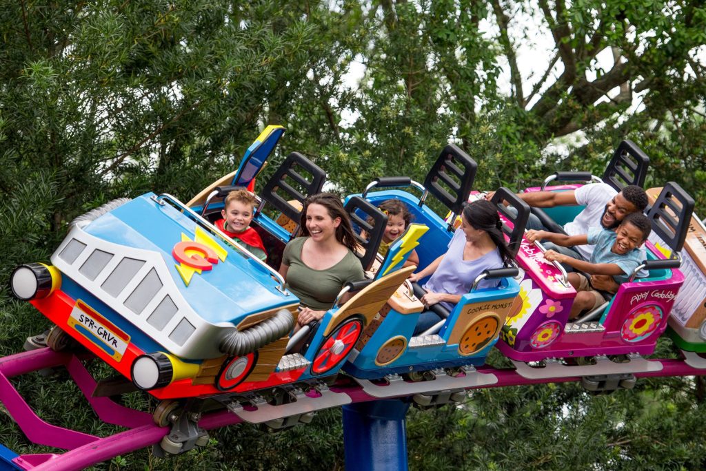 Parents and children ride a roller coaster at SeaWorld, an Orlando attraction with a Florida teachers discount.