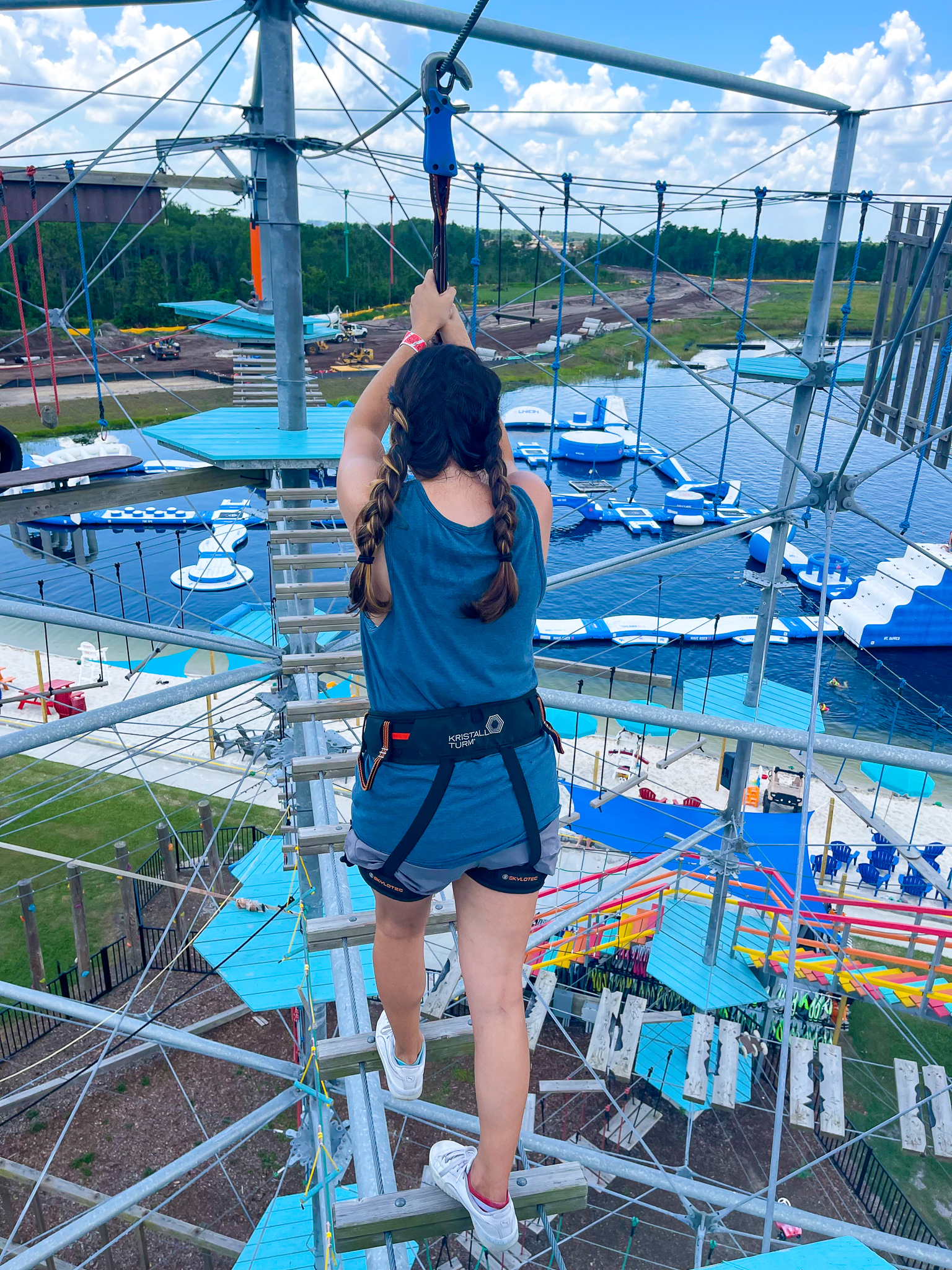 A guest climbs through an obstacle course at Nona Adventure Park, a unique water park in southeast Orlando