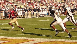 Florida State Football Player Lorenzo Booker running with the ball. One of the two teams playing in the 2023 Camping World Kickoff.
